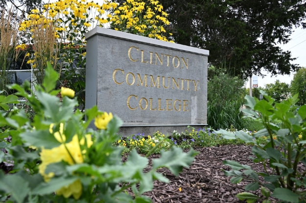 A stone sign that reads Clinton Community College surrounded by a garden